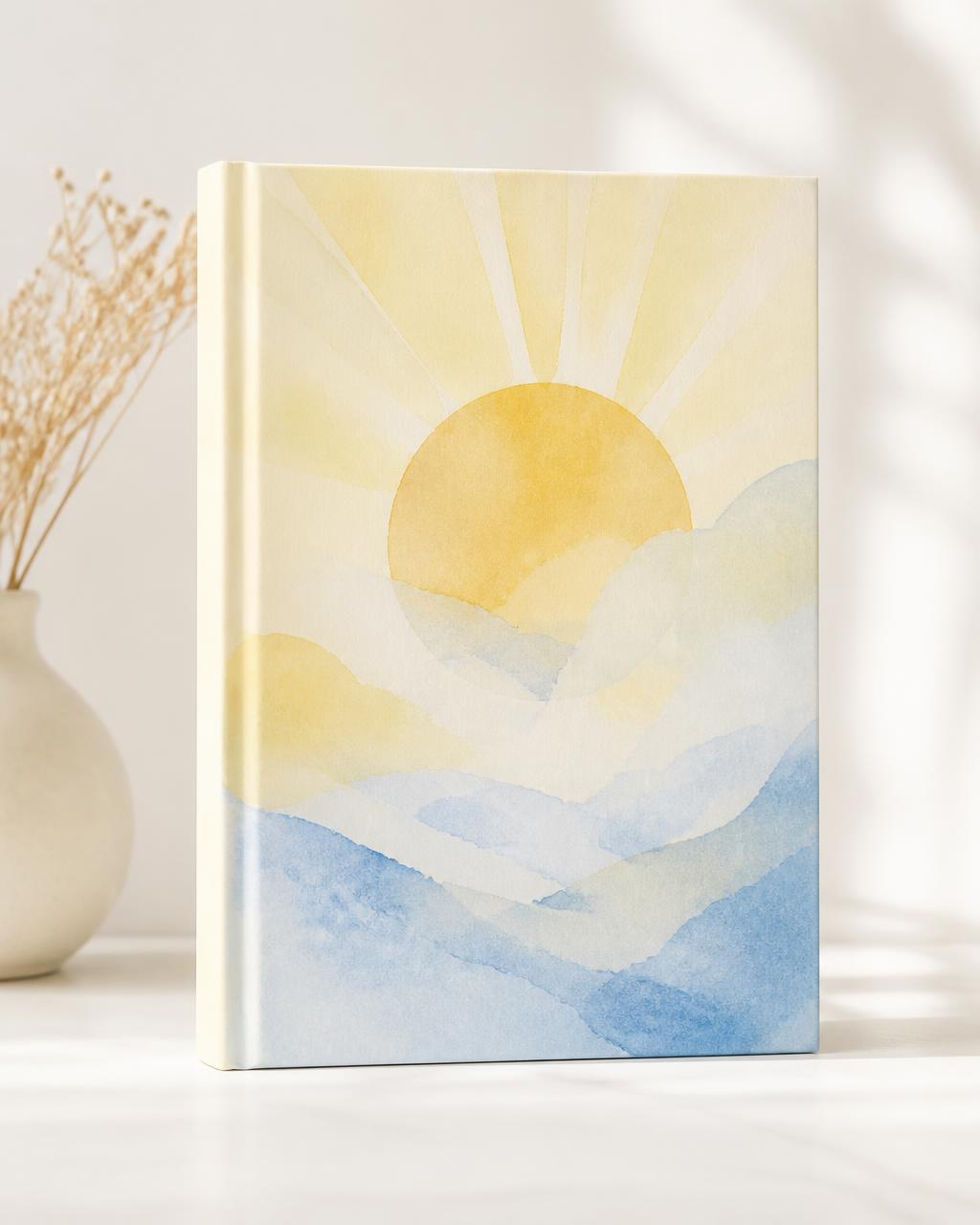 The Through The Storm, We Shine Together journal, a soft sunrise watercolor cover